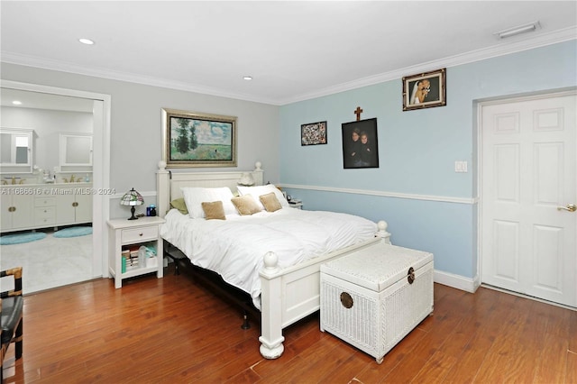 bedroom with connected bathroom, crown molding, and dark hardwood / wood-style flooring