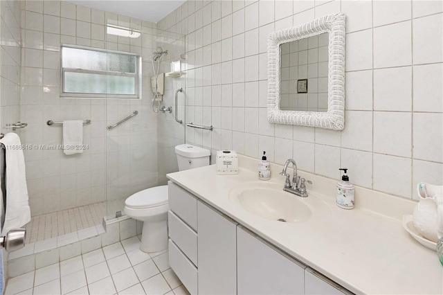 bathroom with toilet, vanity, tile walls, and a shower with door