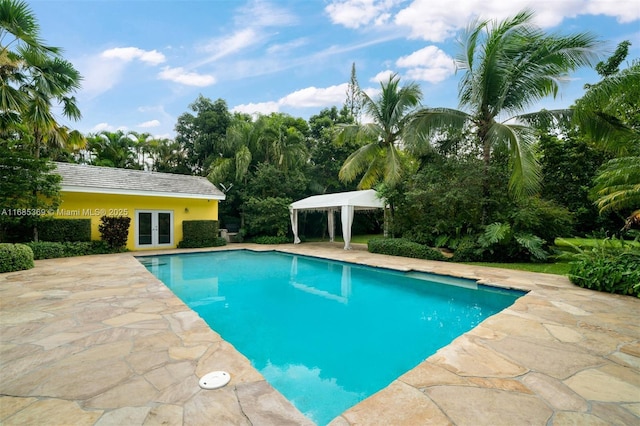 view of pool with a patio area and french doors