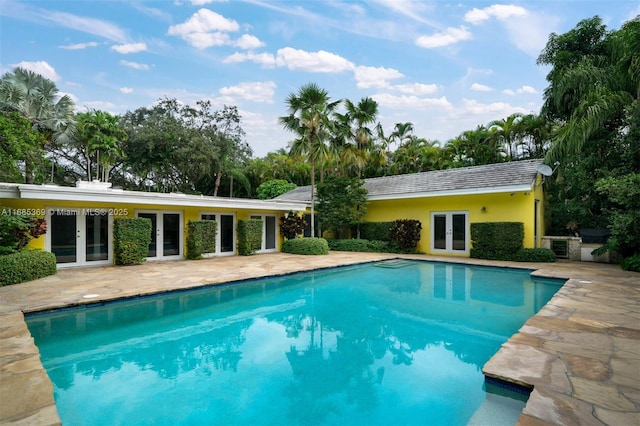 view of swimming pool featuring a patio and french doors