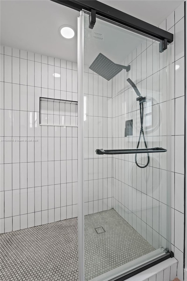 bathroom with a shower with door