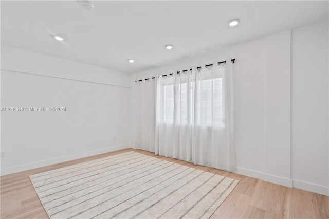 unfurnished room with light hardwood / wood-style flooring