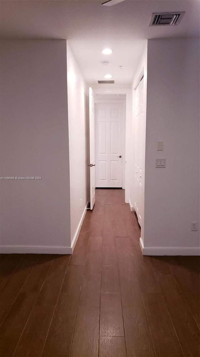 corridor with dark hardwood / wood-style floors