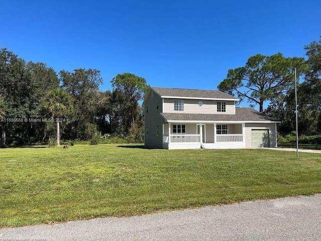 view of front of home featuring a porch, a front yard, and a garage
