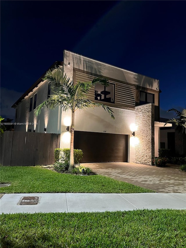 contemporary house with a yard and a garage