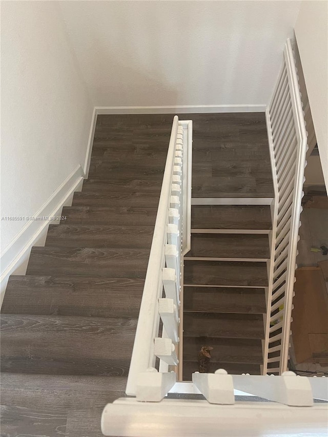 stairway featuring wood-type flooring