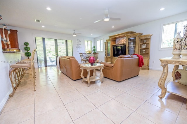 living room with ceiling fan, light tile patterned floors, and plenty of natural light