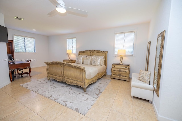 tiled bedroom featuring multiple windows and ceiling fan