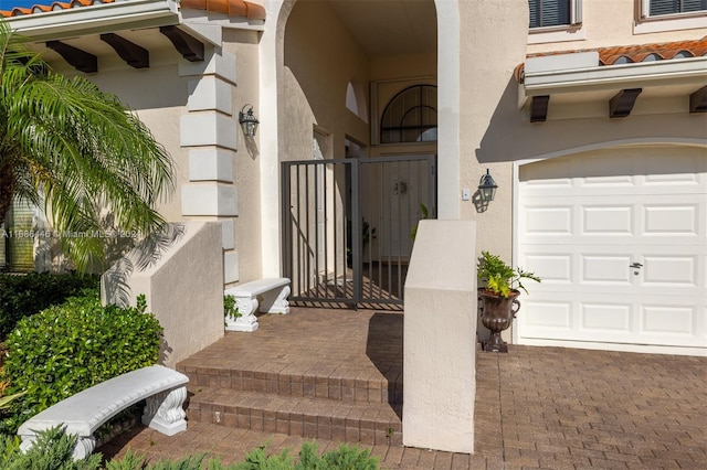 doorway to property with a garage