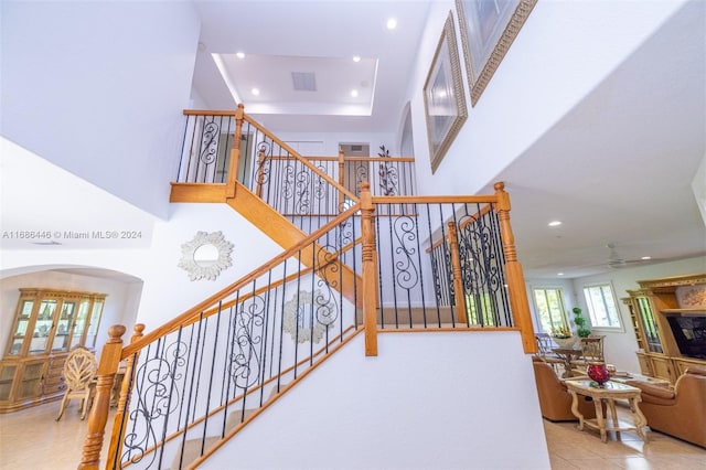 stairs with tile patterned flooring and ceiling fan