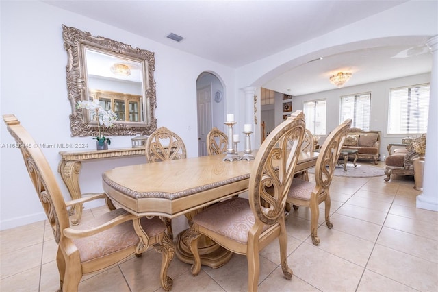 dining room with ornate columns and light tile patterned floors