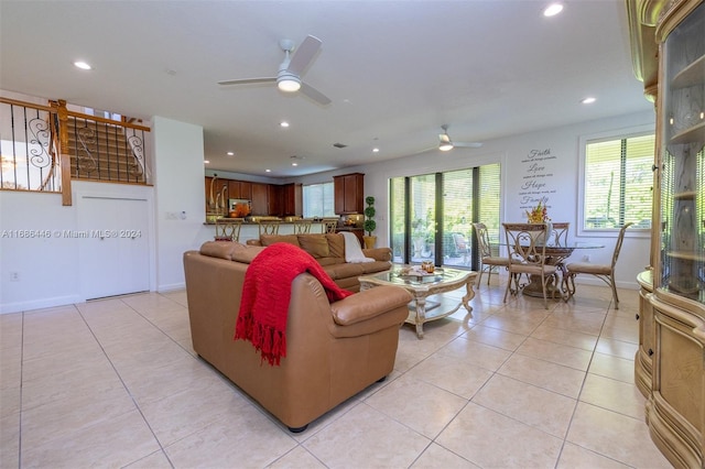 living room with light tile patterned flooring and ceiling fan