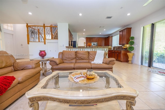 tiled living room featuring sink