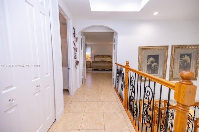 hallway featuring a skylight and light tile patterned floors