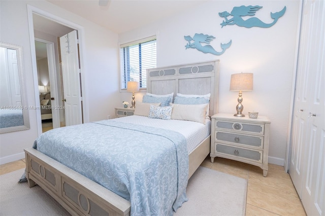 bedroom with ceiling fan, a closet, and light tile patterned floors