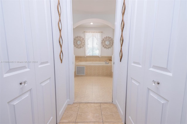 hall featuring light tile patterned floors