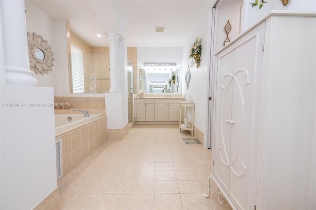 bathroom featuring vanity, decorative columns, tiled bath, and tile patterned floors