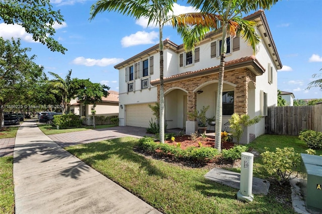 mediterranean / spanish home with a garage