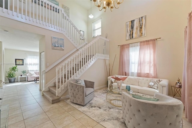 living room featuring a towering ceiling, light tile patterned flooring, and an inviting chandelier