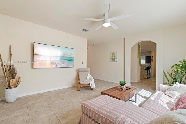 tiled living room featuring ceiling fan