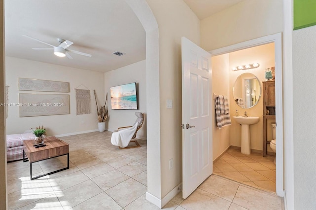 bathroom with tile patterned flooring, toilet, and ceiling fan