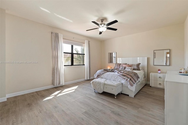 bedroom with ceiling fan and light hardwood / wood-style floors