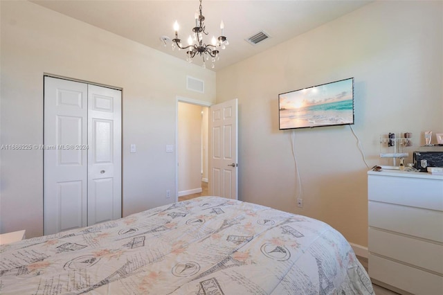 bedroom featuring a closet and a notable chandelier