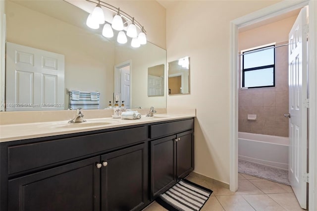 bathroom featuring tile patterned flooring, vanity, and tiled shower / bath