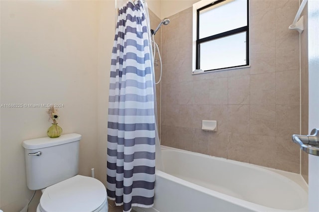 bathroom with shower / bath combination with curtain and toilet