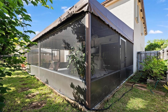 view of property exterior featuring a sunroom