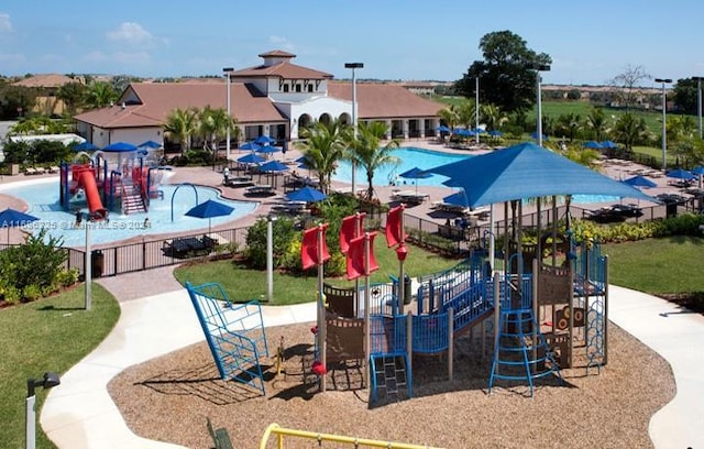 view of swimming pool with a playground