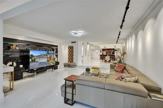 living room featuring light tile patterned floors and track lighting