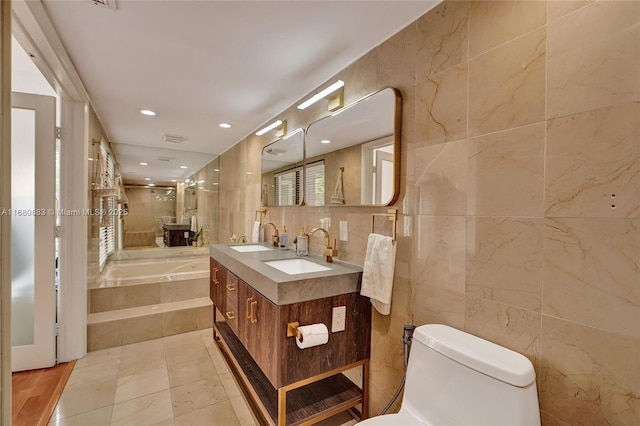 full bathroom featuring tile patterned floors, vanity, separate shower and tub, tile walls, and toilet