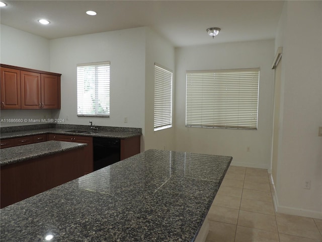 kitchen featuring light tile patterned floors, sink, and black dishwasher