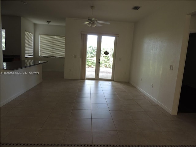 tiled empty room with ceiling fan