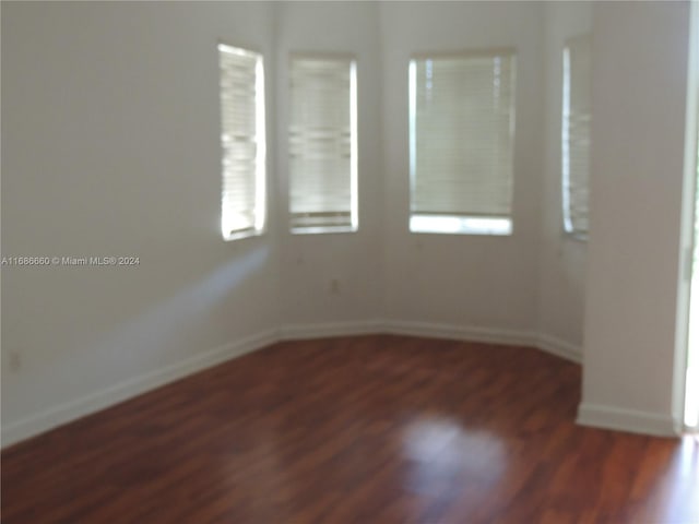 unfurnished room with dark hardwood / wood-style floors