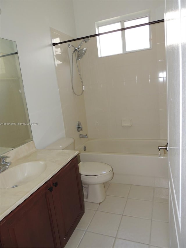 full bathroom with toilet, tiled shower / bath combo, vanity, and tile patterned floors