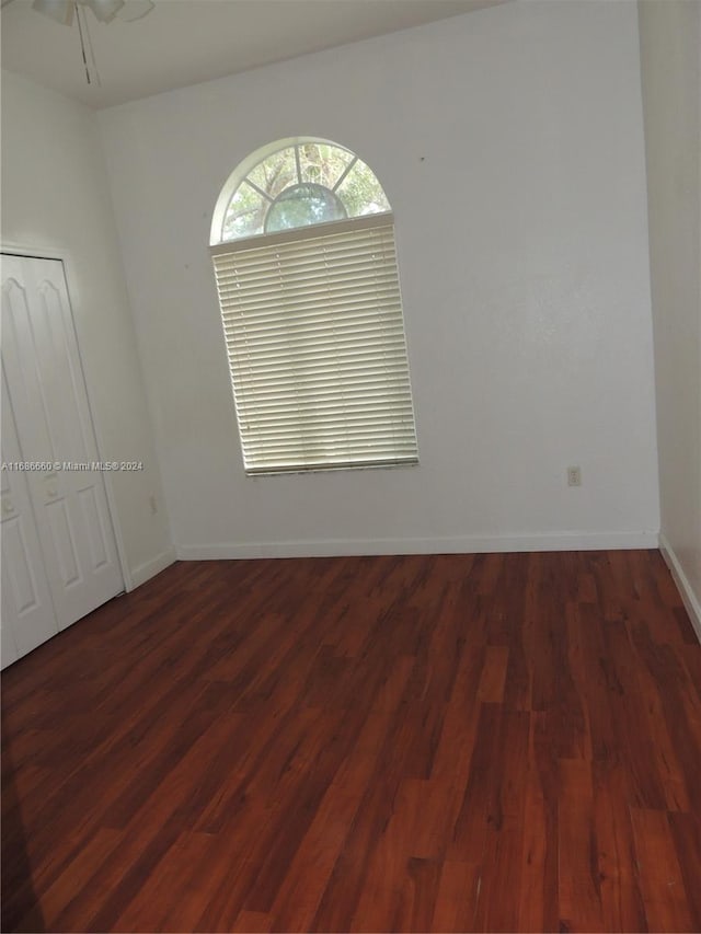 empty room featuring dark hardwood / wood-style flooring and ceiling fan