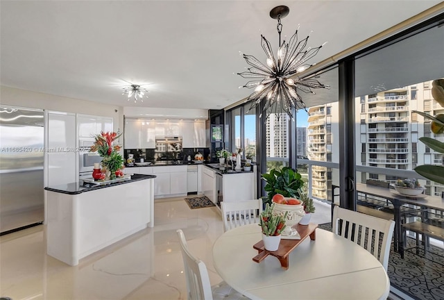 dining room featuring an inviting chandelier and a wall of windows