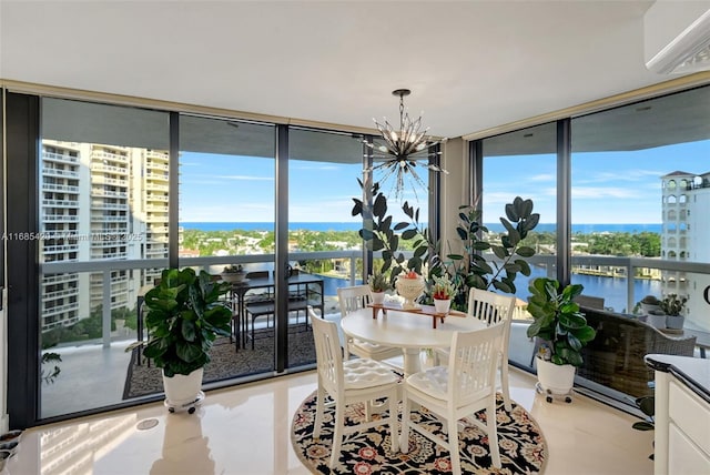 dining space with floor to ceiling windows, a water view, and a chandelier