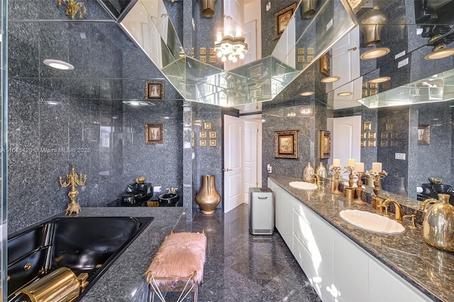 bathroom featuring a bath, vanity, tile walls, and decorative backsplash