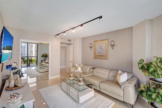 living room with track lighting and a textured ceiling