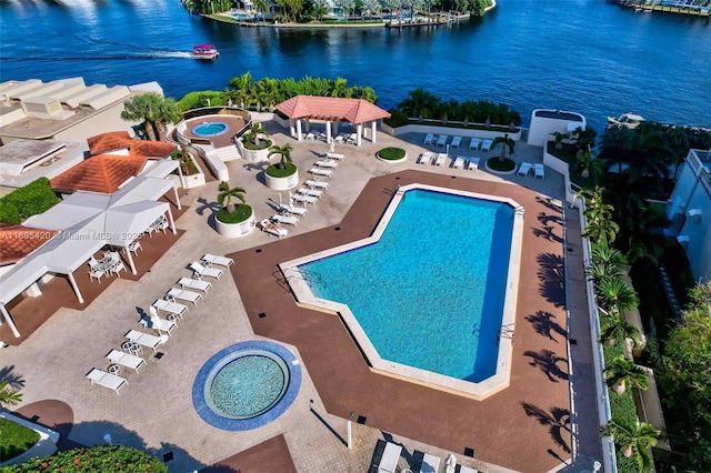 view of pool featuring a water view, a community hot tub, and a gazebo