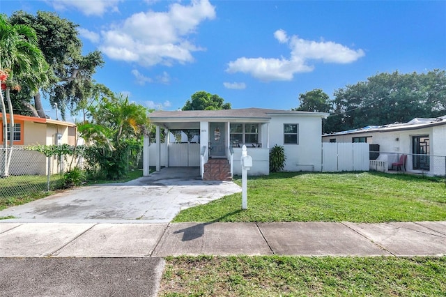 view of front facade with a carport and a front yard