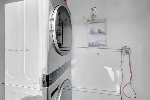 clothes washing area featuring stacked washer / dryer