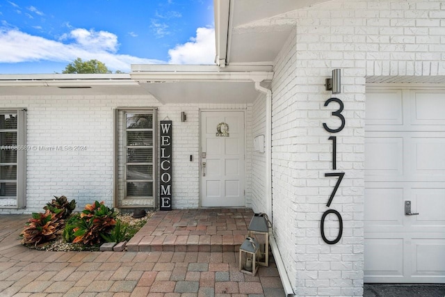 view of exterior entry featuring a garage