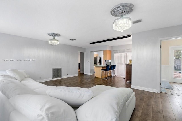 living room featuring dark hardwood / wood-style floors and a chandelier