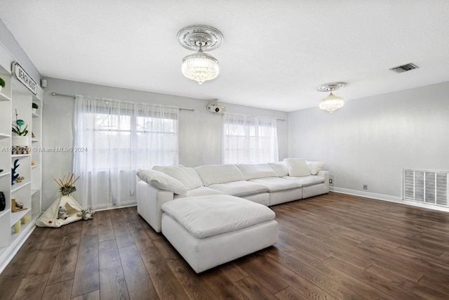 living room featuring a textured ceiling and dark hardwood / wood-style floors