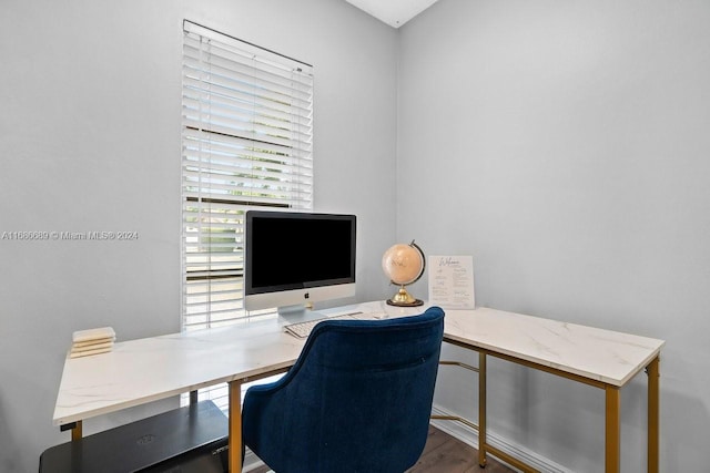 home office with hardwood / wood-style flooring