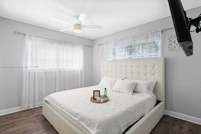 bedroom featuring dark hardwood / wood-style floors, a textured ceiling, and ceiling fan